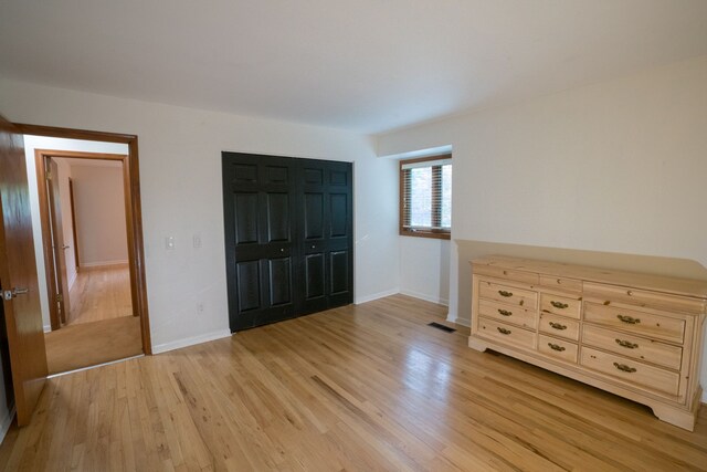 45778 Fermanagh Dr, Northville, MI 48168 - unfurnished bedroom featuring visible vents, light wood-type flooring, baseboards, and a closet