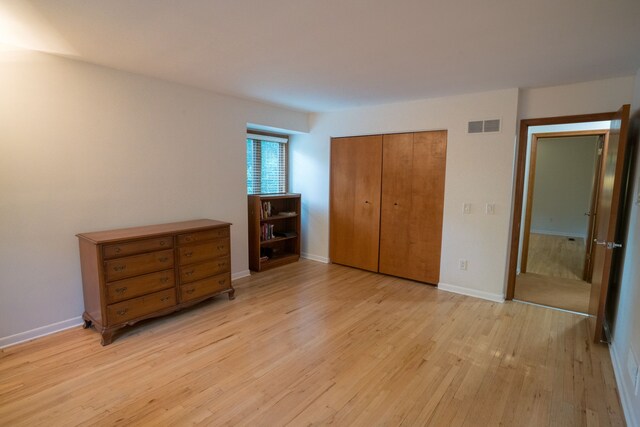 45778 Fermanagh Dr, Northville, MI 48168 - unfurnished bedroom with visible vents, light wood-type flooring, baseboards, and a closet