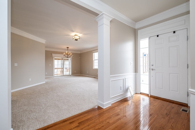 49128 Rainbow Ln S, Northville, MI 48168 - entrance foyer with visible vents, baseboards, ornamental molding, a chandelier, and wood finished floors