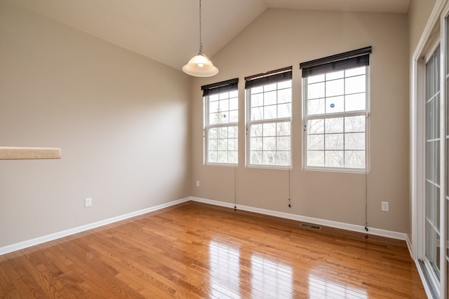 49128 Rainbow Ln S, Northville, MI 48168 - empty room with visible vents, baseboards, light wood finished floors, and lofted ceiling