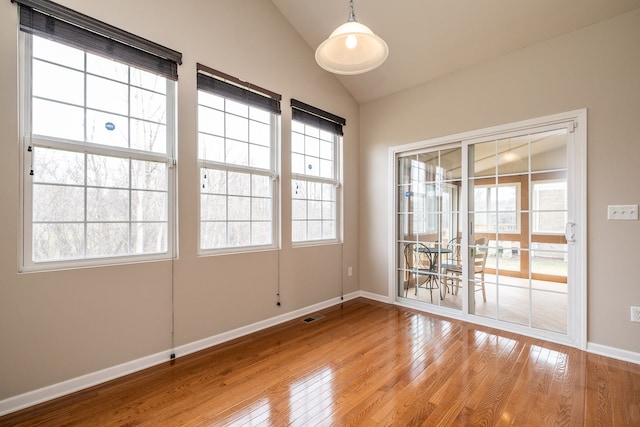 49128 Rainbow Ln S, Northville, MI 48168 - empty room featuring plenty of natural light, light wood-style flooring, visible vents, and lofted ceiling