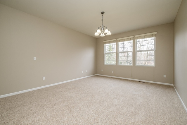 49128 Rainbow Ln S, Northville, MI 48168 - unfurnished room featuring visible vents, light colored carpet, a notable chandelier, and baseboards