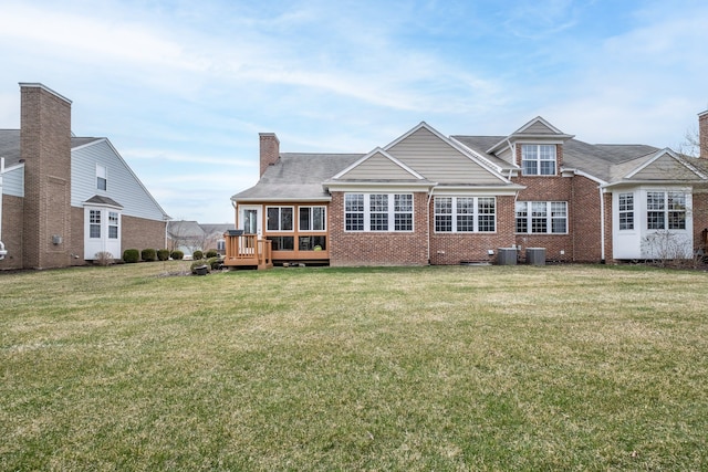 49128 Rainbow Ln S, Northville, MI 48168 - back of property with brick siding, a wooden deck, a lawn, and a chimney