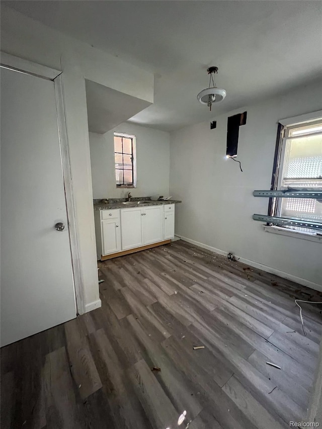 3945 Devonshire Rd, Detroit, MI 48224 - kitchen featuring white cabinets, dark wood-style flooring, baseboards, and a sink