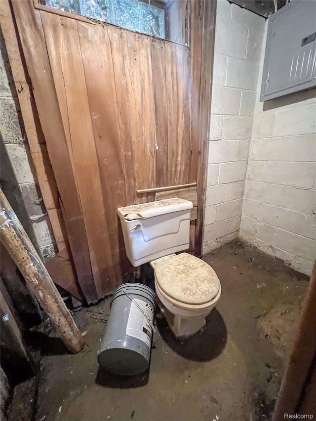 3945 Devonshire Rd, Detroit, MI 48224 - bathroom featuring toilet, electric panel, concrete block wall, and concrete floors
