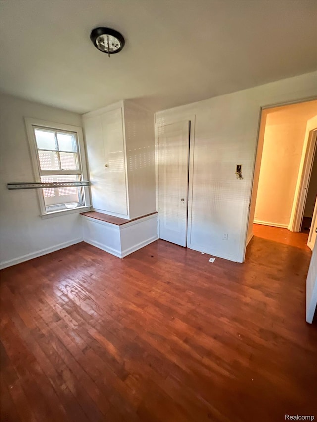 3945 Devonshire Rd, Detroit, MI 48224 - unfurnished bedroom with wood finished floors, baseboards, and a closet