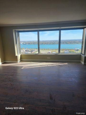 1300 E Lafayette St Unit 2803, Detroit, MI 48207 - spare room with wood finished floors and ornamental molding