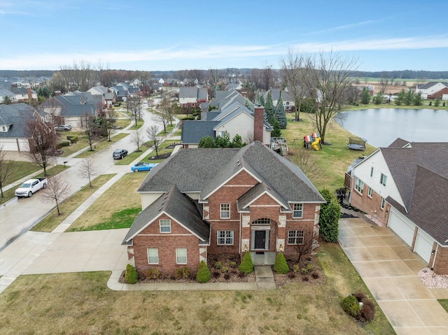 drone / aerial view featuring a water view and a residential view