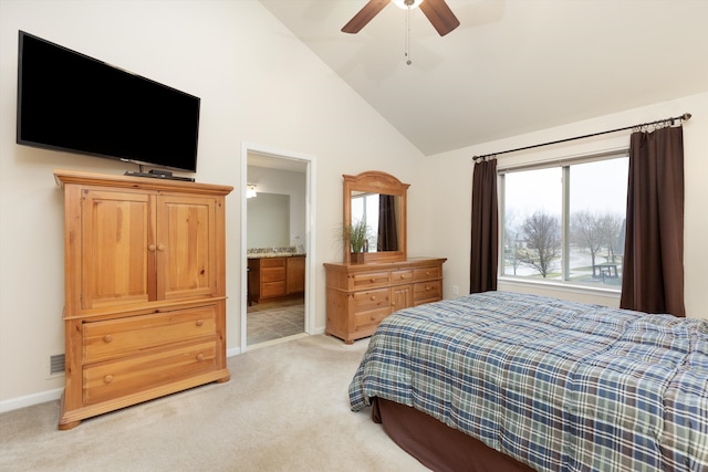 bedroom featuring high vaulted ceiling, baseboards, ceiling fan, ensuite bath, and light carpet