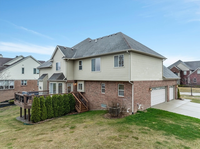 back of property featuring a lawn, brick siding, driveway, and a wooden deck
