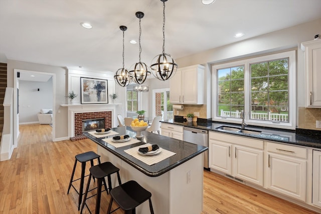 45055 Walnut Rdg, Northville, MI 48168 - kitchen with stainless steel dishwasher, a sink, decorative backsplash, white cabinets, and recessed lighting