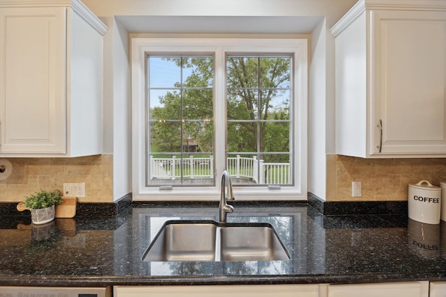 45055 Walnut Rdg, Northville, MI 48168 - kitchen with a sink, decorative backsplash, dark stone counters, and white cabinetry