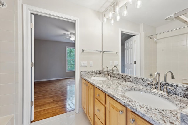 45055 Walnut Rdg, Northville, MI 48168 - full bathroom with double vanity, ceiling fan, baseboards, a shower, and wood finished floors