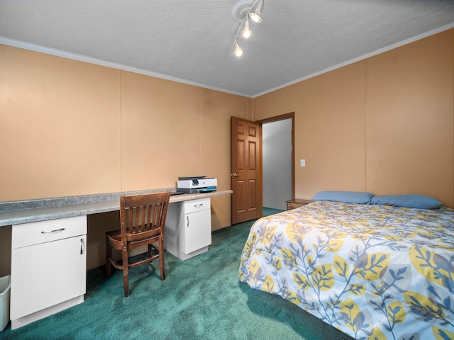 carpeted bedroom with built in desk, ornamental molding, and a textured ceiling