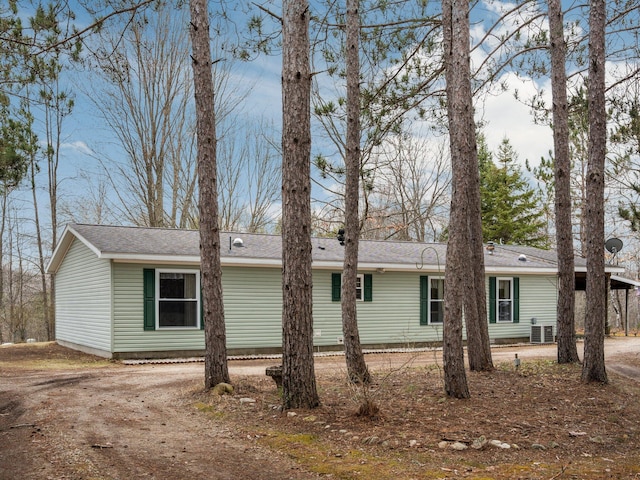 exterior space with roof with shingles and driveway