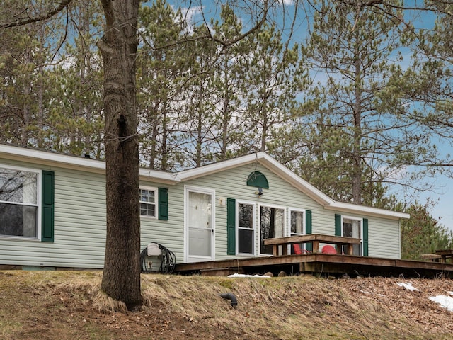 back of house featuring a wooden deck