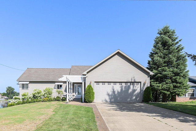ranch-style house featuring a front lawn, a shingled roof, a garage, and concrete driveway