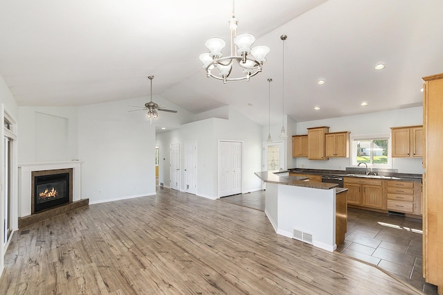 kitchen with visible vents, light wood finished floors, a sink, dishwashing machine, and ceiling fan with notable chandelier