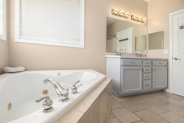full bath with a tub with jets and double vanity