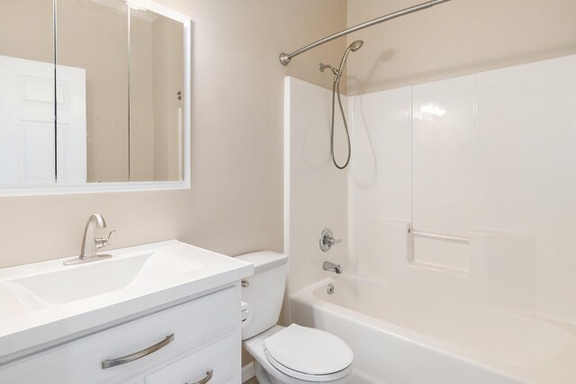 bathroom featuring toilet, vanity, and shower / bathtub combination