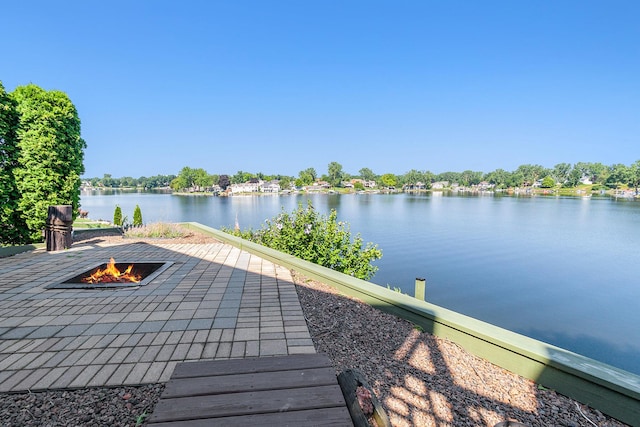 view of patio featuring a fire pit and a water view