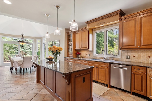 kitchen featuring tasteful backsplash, a sink, a healthy amount of sunlight, and dishwasher