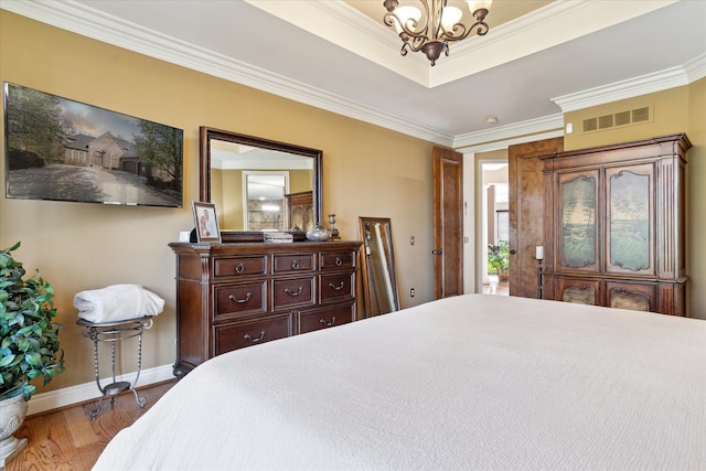 bedroom with visible vents, ornamental molding, baseboards, and an inviting chandelier