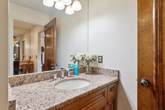 bathroom featuring an inviting chandelier and vanity