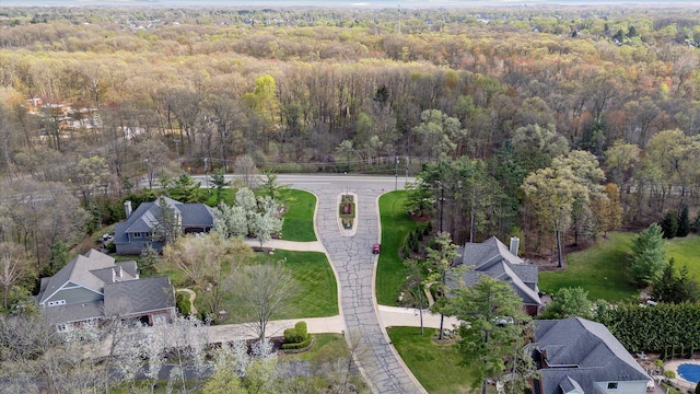 drone / aerial view featuring a residential view and a view of trees