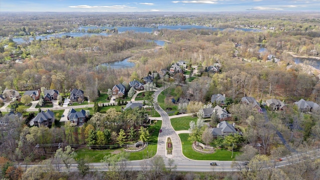aerial view with a water view, a residential view, and a forest view