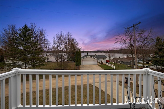 14319 Park Dr, Mecosta, MI 49332 - deck featuring a garage, a residential view, a yard, and driveway