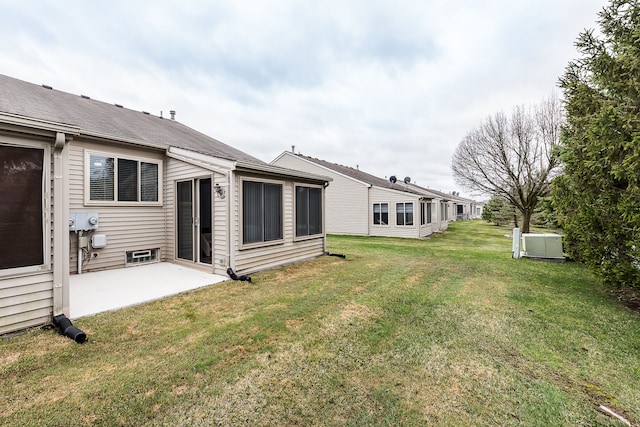 back of property featuring a patio area and a lawn