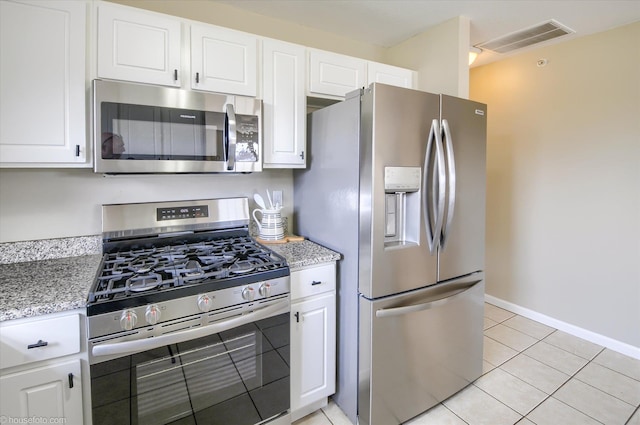 kitchen with white cabinetry, visible vents, appliances with stainless steel finishes, and light tile patterned floors