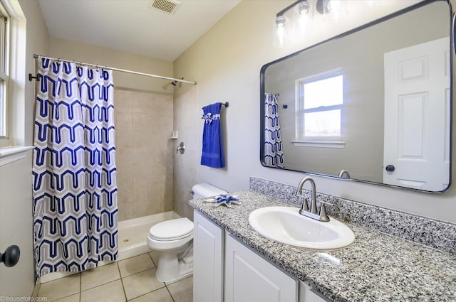bathroom featuring visible vents, toilet, vanity, a stall shower, and tile patterned flooring