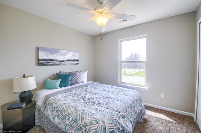 bedroom featuring baseboards, visible vents, carpet, and a ceiling fan