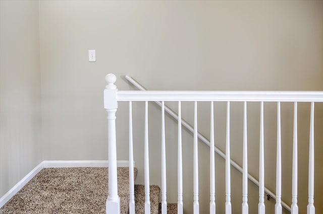 staircase with carpet floors and baseboards