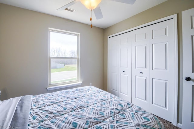 bedroom featuring a closet, ceiling fan, and visible vents