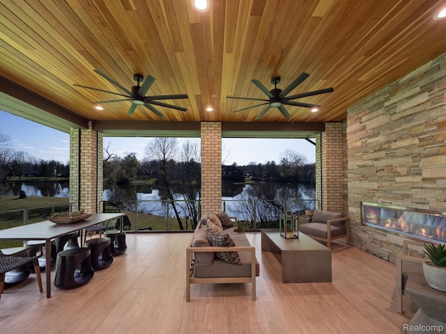 4274 Wendell Rd, West Bloomfield, MI 48323 - view of patio featuring ceiling fan, a water view, and an outdoor living space with a fireplace