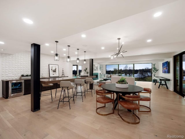 4274 Wendell Rd, West Bloomfield, MI 48323 - dining room featuring wine cooler, light wood-type flooring, recessed lighting, a chandelier, and bar