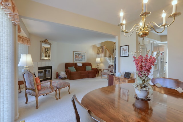 18735 Hilltop Blvd, Riverview, MI 48193 - carpeted dining area featuring stairs, a tile fireplace, and an inviting chandelier