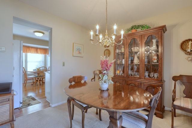 18735 Hilltop Blvd, Riverview, MI 48193 - dining area with light colored carpet, a chandelier, and baseboards