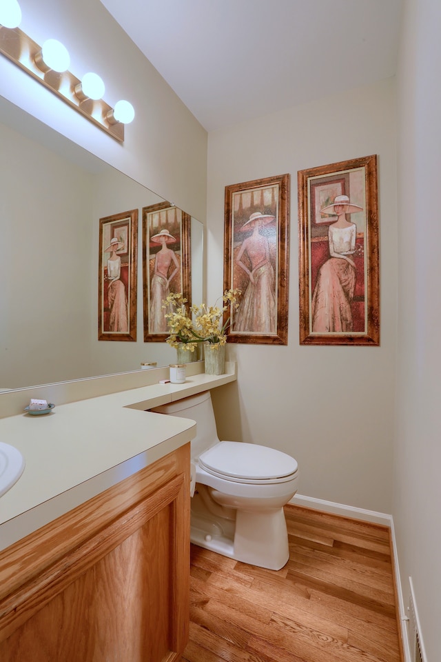 18735 Hilltop Blvd, Riverview, MI 48193 - half bathroom featuring toilet, wood finished floors, vanity, and baseboards
