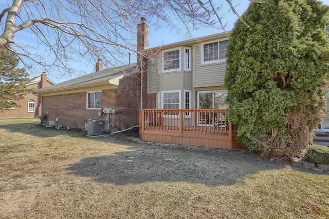 18735 Hilltop Blvd, Riverview, MI 48193 - back of house featuring central air condition unit, a chimney, brick siding, a yard, and a deck