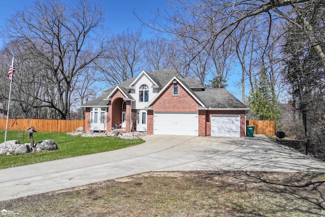 501 Dutch Mill Dr, Flushing, MI 48433 - view of front of house with brick siding, driveway, and an attached garage