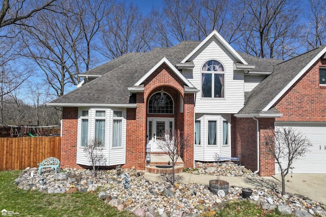 501 Dutch Mill Dr, Flushing, MI 48433 - view of front of property featuring fence, brick siding, a shingled roof, and an attached garage