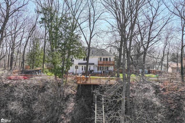 501 Dutch Mill Dr, Flushing, MI 48433 - rear view of property with a deck, a shingled roof, and stucco siding