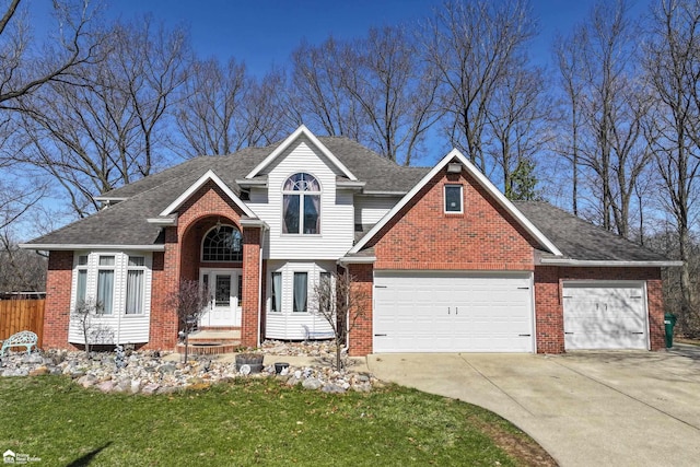 501 Dutch Mill Dr, Flushing, MI 48433 - view of front of home featuring brick siding, a garage, driveway, and a shingled roof