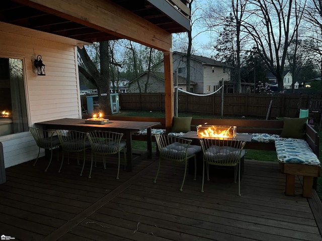 501 Dutch Mill Dr, Flushing, MI 48433 - deck with a fire pit, outdoor dining space, and a fenced backyard