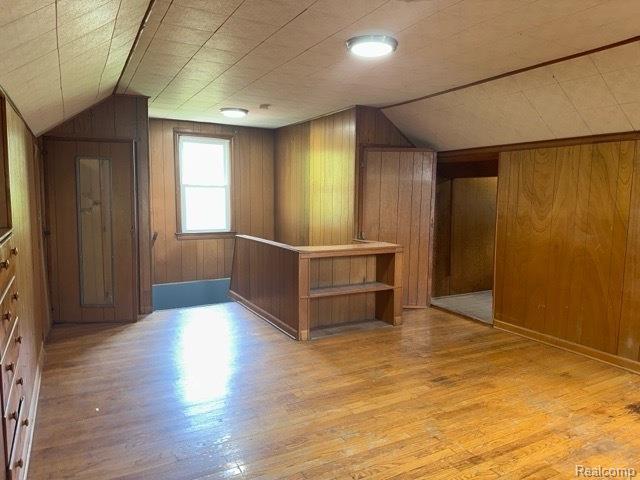 19533 Barlow St, Detroit, MI 48205 - bonus room featuring wood walls, lofted ceiling, and light wood finished floors