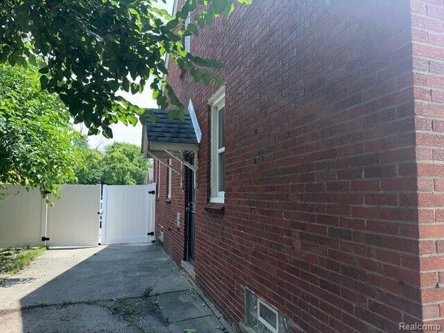 19533 Barlow St, Detroit, MI 48205 - view of property exterior featuring a gate and brick siding